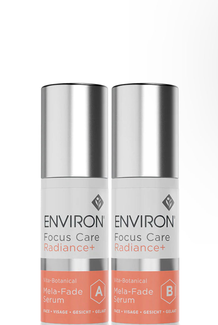 Two bottles of Environ Mela Fade Serum, one standing upright and the other lying down, against a white background.