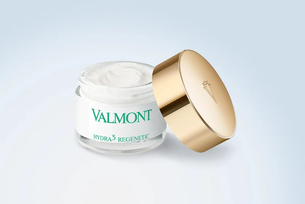 Valmont skincare cream jar with gold lid on a light gray background